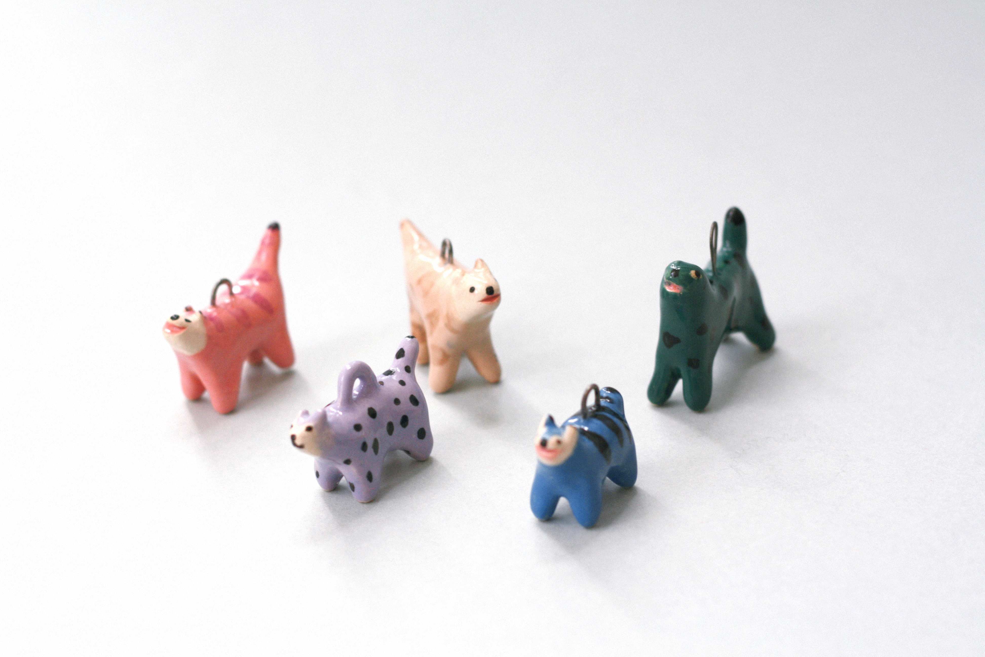 Handmade ceramic cat charms in colorful designs by Anja Bartelt 