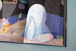 Illustration of a dreamy blue creature sitting on a moon-like surface, looking into space, with small planets and a green alien figure in the background. 